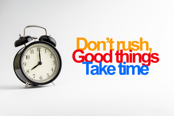 DON'T RUSH GOOD THINGS TAKE TIME inscription written and alarm clock on white background. Business and motivation concept
