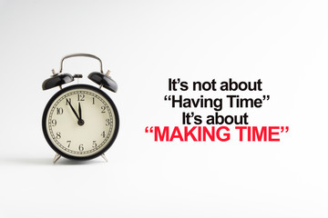 IT'S NOT ABOUT HAVING TIME IT'S ABOUT MAKING TIME inscription written and alarm clock on white background. Business and motivation concept