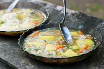 fish soup in tarek on old wooden table