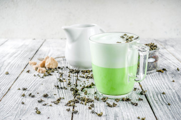 Tea latte, Hot Tokyo Fog Tea Drink with Foamed Milk and Matcha, wooden background copy space