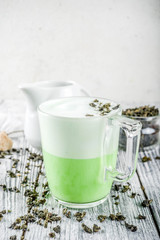 Tea latte, Hot Tokyo Fog Tea Drink with Foamed Milk and Matcha, wooden background copy space