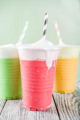 Summer colorful iced fog tea drinks, with tea, honey, matcha, lemonade,with foamed milk, wooden background copy space