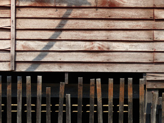 old wood wall home with wood fence