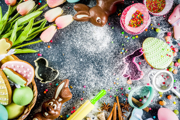 Easter greeting card background. Cooking gingerbread cookies ingredients, With colorful eggs. cookies and sugar sprinkles top view copy space