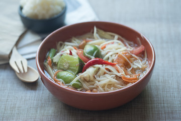 Somtum or papaya salad with red hot chili and Thai herb sauce