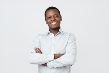Laughing handsome young african man in shirt smiling confident