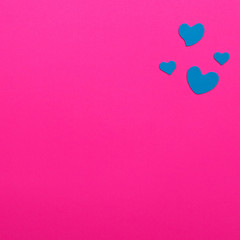 Blue heart on pink paper