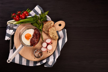 fried eggs with cherry tomatoes on the grill with bread