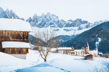Dolomites mountain peaks with Val di Funes village in winter, South Tyrol, Italy