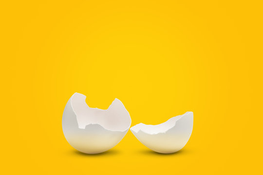 Two egg shell parts on yellow background with shadows