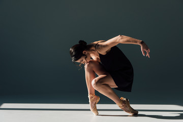 elegant beautiful ballerina in black dress dancing in sunlight © LIGHTFIELD STUDIOS