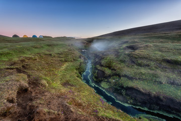 Camp in the Laugarvallardalur valley with hot springs, Iceland. Night landscape of amazing nature, outdoor travel background