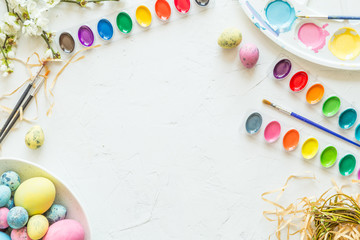 Easter eggs, paint and brushes. Holiday concept. Flat lay. Top view. Place for text