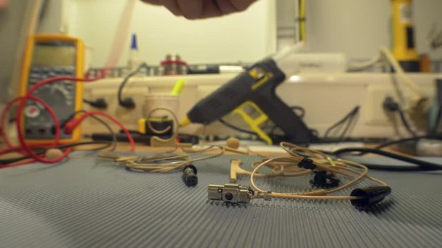 Electronics engineer testing and repairing electronic cables in his workshop - accelerated video