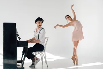 Foto op Plexiglas musician playing piano while attractive ballerina dancing near him © LIGHTFIELD STUDIOS