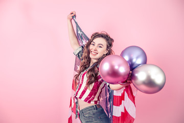 Obraz na płótnie Canvas Patriotic girl with the flag of America on a colored background