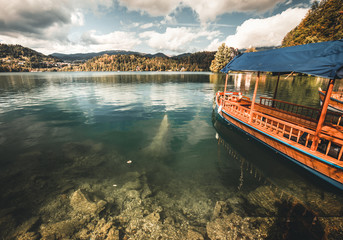 Naklejka premium Traditional Pletna boat on the lake. .Bled lake Slovenia,Europe