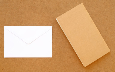 Book with envelope on wood