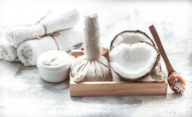 Spa still life with fresh coconut and body care products