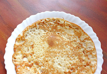 Fried pancake on a white plate