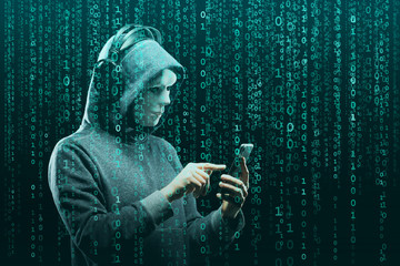 Anonymous computer hacker over abstract digital background. Obscured dark face in mask and hood. Data thief, internet attack, darknet fraud, dangerous viruses and cyber security.