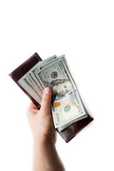 Female hand holds opened brown wallet with a thick wad of new one hundred dollar bills. isolated over a white background. vertical