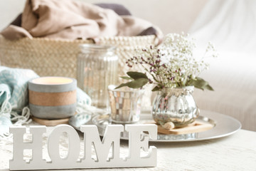 Home decorations in the interior of a letter with an inscription home on a wooden background
