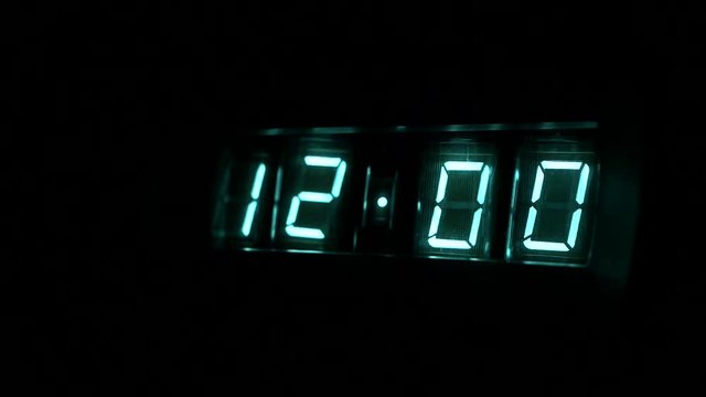 Lamp neon clock glow in the dark. watch time 11 ; 59 to 12 : 00