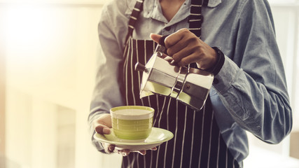 Barista making Espresso,  Americano, Cappuccino, Latte, Mocha, and preparing coffee drink.