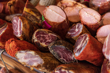 Variety of processed cold meat products. Assortment of diferent cold meats in a basket