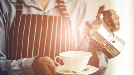 Barista making Espresso,  Americano, Cappuccino, Latte, Mocha, and preparing coffee drink.