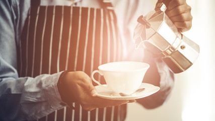 Barista making Espresso,  Americano, Cappuccino, Latte, Mocha, and preparing coffee drink.