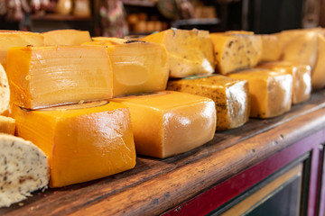 Different sort of cheeses on a wooden board for sale
