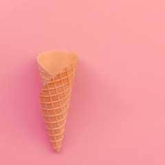 Cone for ice cream on a coral background. Empty cone for ice cream with a place for copy-paste.