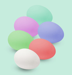 Multi-colored Easter eggs. Holiday in the house. Isolated on light green background.