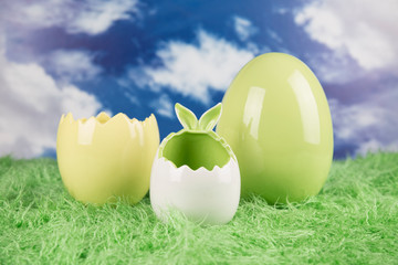 Easter, colorful eggs on green grass.