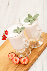Delicious strawberry yogurt with mint leaves in glasses.