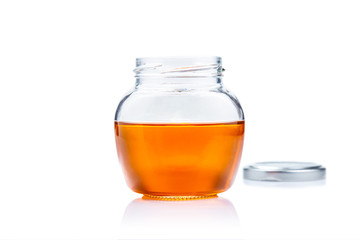 Honey glass jar on white background with copy space