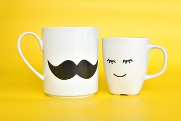 Two emotional coffee cups stand together, men and woman, romantic, love, Happy Valentines day concept.