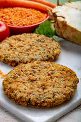 Tasty vegetarian food, raw burgers made from lentils legumes with vegetables ready for cooking