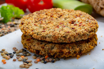 Tasty vegetarian food, raw burgers made from lentils legumes with vegetables ready for cooking
