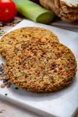 Tasty vegetarian food, raw burgers made from lentils legumes with vegetables ready for cooking