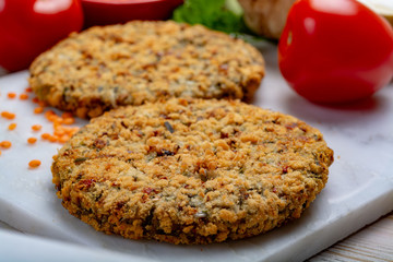 Tasty vegetarian food, raw burgers made from lentils legumes with vegetables ready for cooking
