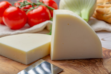 Italian cheese, Provolone dolce cow cheese from Cremona served with olive bread and tomatoes