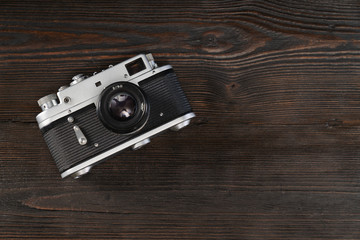 Vintage camera on a grungy wooden background