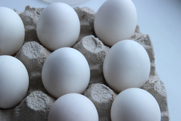 Chicken egg is half broken among other eggs