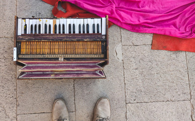 Old Harmonium with bright pink silk.
