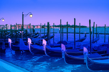Gondolas in night time at the Piazza San Marco, Venice, Italy