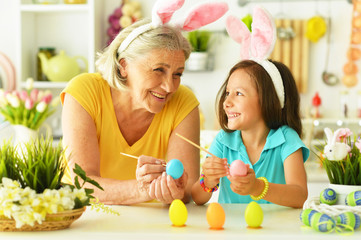 Senior grandmother and granddaughter with  Easter eggs