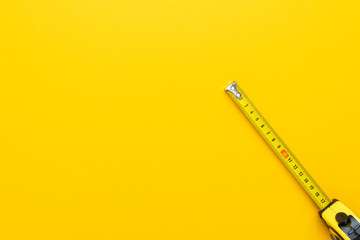 tape measure on the yellow background with copy space